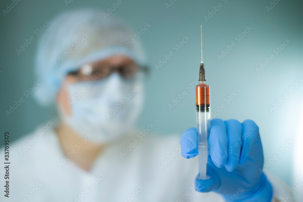 Nurse in the lab with a syringe, blood test for coronavirus. Nurse in the lab with a syringe, blood test for coronavirus.