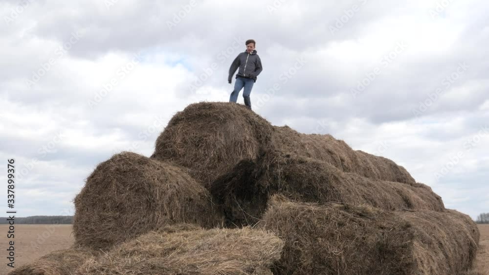 child play with a stack of straw against the sky child play with a stack of straw against the sky
