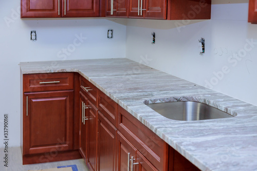 Installing new kitchen counter top new cabinet in a home