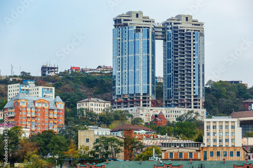Summer, 2015 - Vladivostok, Russia - The marine facade of Vladivostok. Residential and business buildings located on the green hills of the capital of the Far East, Vladivostok © alexhitrov