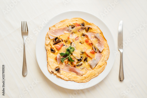 Homemade beaten eggs soft omelette.Colorful healthy breakfast at home.Home cooked meal served.Low calorie food,low carb lifestyle eating in.Keto meal.Delicious colorful basic French omelet recipe.