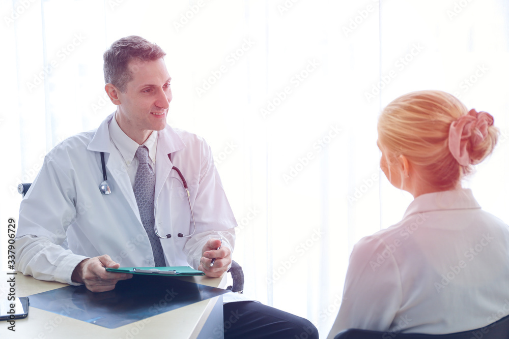 Professional doctor interview or talking with woman patient in hospital room or clinic, healthcare diagnosis disease concept
