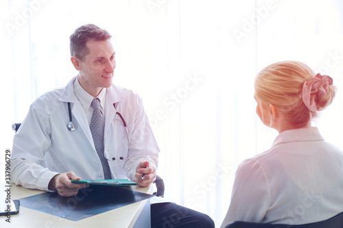 Professional doctor interview or talking with woman patient in hospital room or clinic, healthcare diagnosis disease concept © torsakh