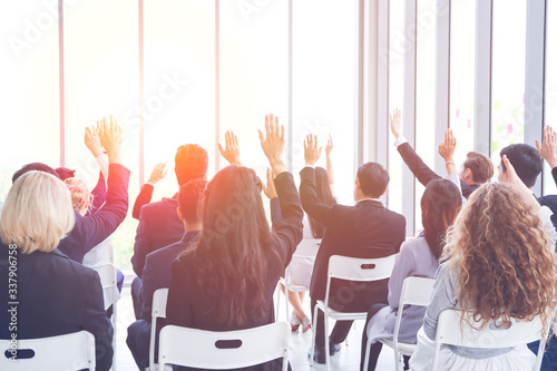 Group of business people or employees meeting or seminar in office hall, executive or professional smart speaker speaking on podium 