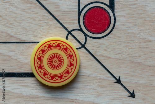 Carom striker on carom board.