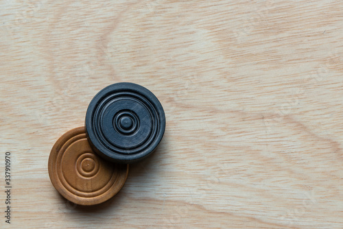 Carom board with striker and carom men. Selective focus.