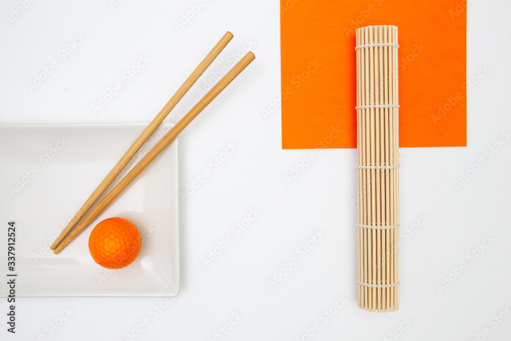 Top View Of White Empty Sushi Plates With Bamboo Chopsticks and Golf Ball. Top View Of White Empty Sushi Plates With Bamboo Chopsticks and Golf Ball.
