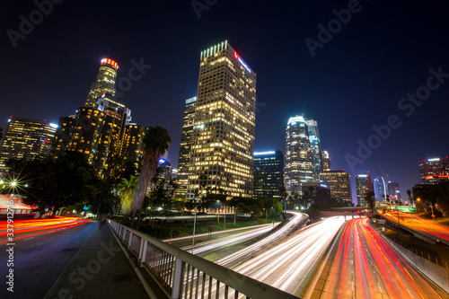 Long exposure photo of cars racing along the 110 Freeway through Downtown Los Angeles  California during evening rush hour.