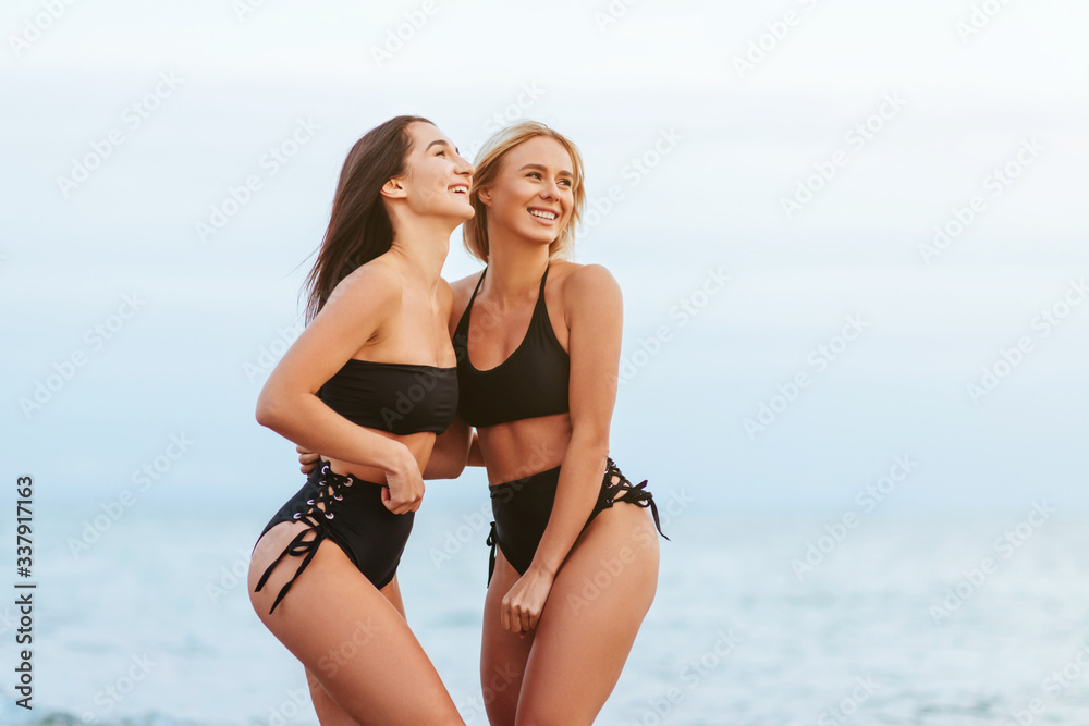 Two Beautiful Attractive Young Women on the Beach