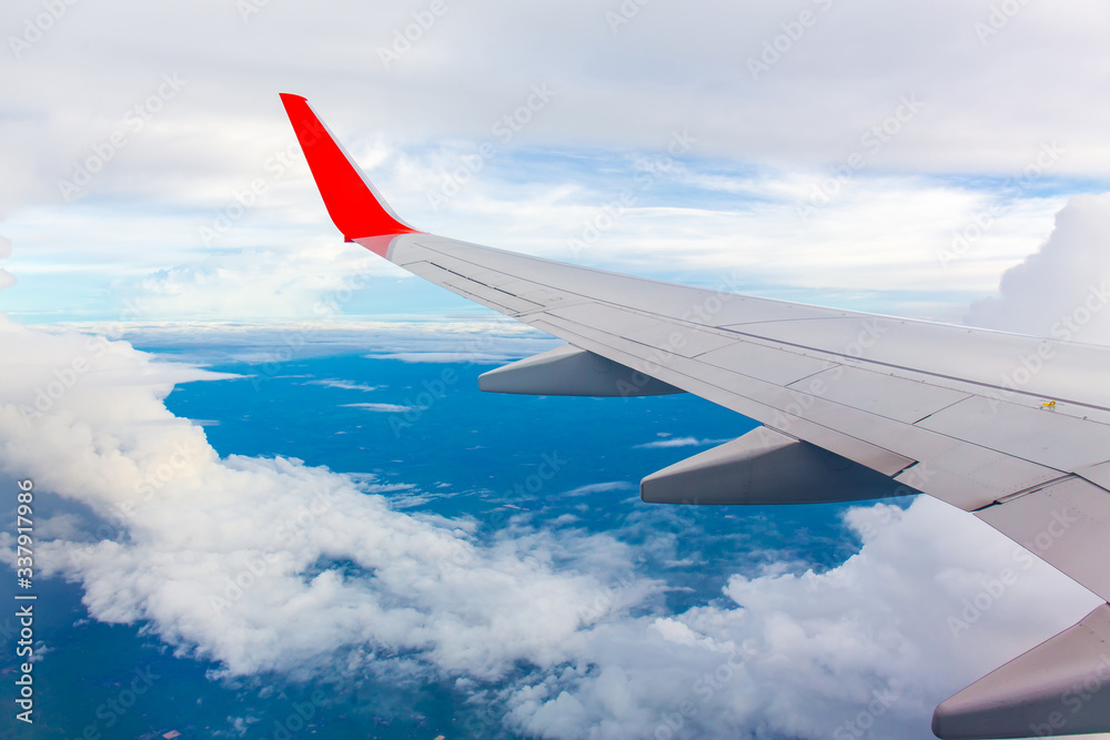 Wing of an airplane. Photo applied to tourism operators and fast and efficient transportation. picture for add text message or art work frame website. Traveling concept. Wing of an airplane. Photo applied to tourism operators and fast and efficient transportation. picture for add text message or art work frame website. Traveling concept.