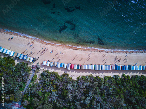 Top down aerial view of a row of Brighton Bathing Boxes
beach Melbourne Australia with beautiful turquoise water
