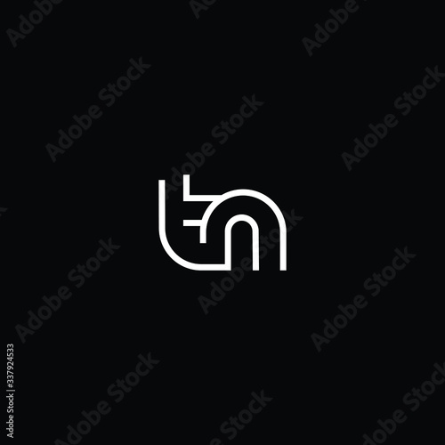 Minimal elegant monogram art logo. Outstanding professional trendy awesome artistic TN NT initial based Alphabet icon logo. Premium Business logo White color on black background photo
