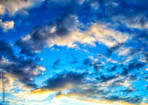 Cumulus clouds in a bright blue sky © Alexandr