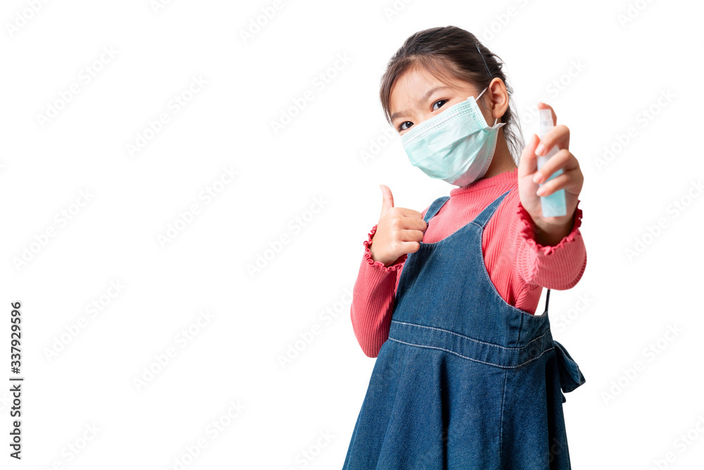 Asian girl wearing medical protective face mask for protect infection the virus and show thumbs up sign and hold alcohol spray bottle isolated on white background, With clipping path. Asian girl wearing medical protective face mask for protect infection the virus and show thumbs up sign and hold alcohol spray bottle isolated on white background, With clipping path.