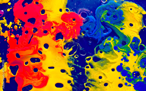 Yellow, scarlet and blue watercolor ink in blue oil water. Cool trending screensaver. photo