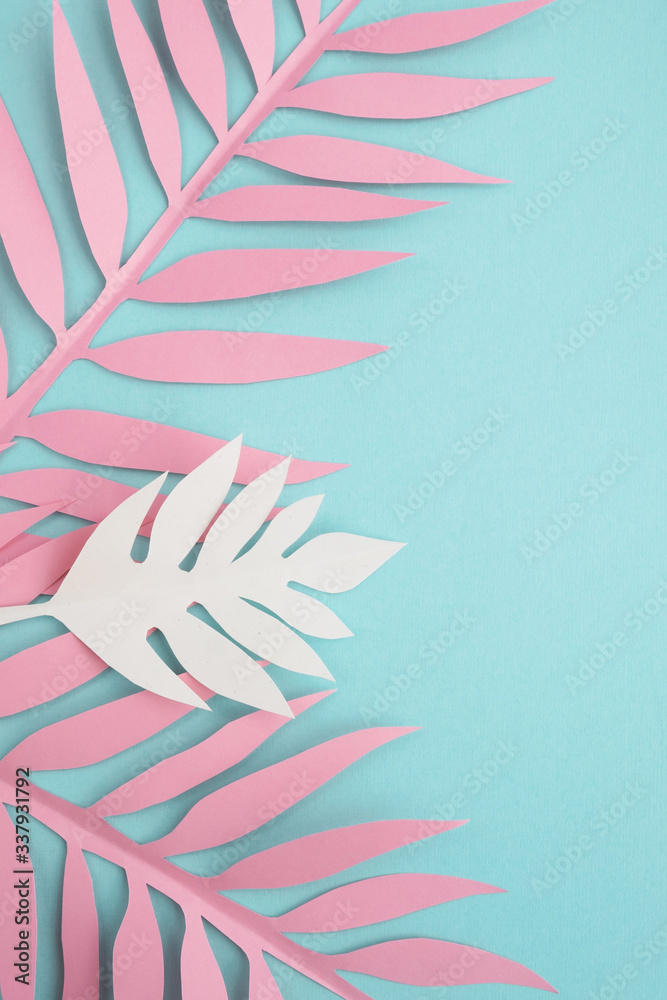 Paper tropical leaves on mint background. Bright summer composition. Top view, flat lay, copy space