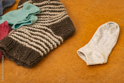 Photo with socks arranged in pairs after washing and one toe without a pair. Concept - Lost Sock and Loneliness