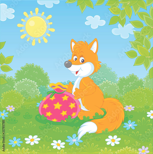 Friendly smiling red fox holding a beautiful bag with a holiday gift on green grass of a pretty forest glade on a sunny summer day, vector cartoon illustration
