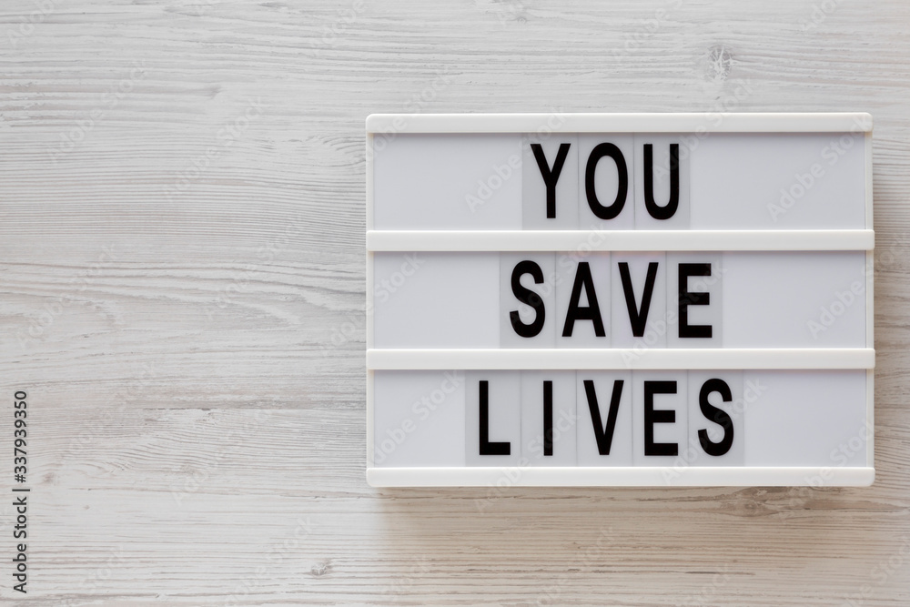 'You save lives' words on a lightbox on a white wooden background, top view. Overhead, from above, flat lay. Copy space. 'You save lives' words on a lightbox on a white wooden background, top view. Overhead, from above, flat lay. Copy space.
