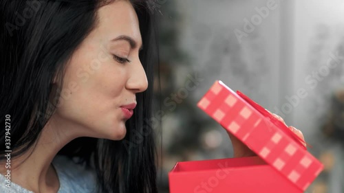 Close up face of excited young girl open gift box having desired present. Shot with RED camera in 4K