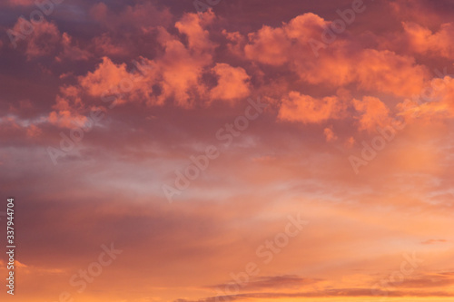 Fototapeta Naklejka Na Ścianę i Meble -  Colorful bright golden and pink clouds in blue heaven on sunset as abstract background, texture.