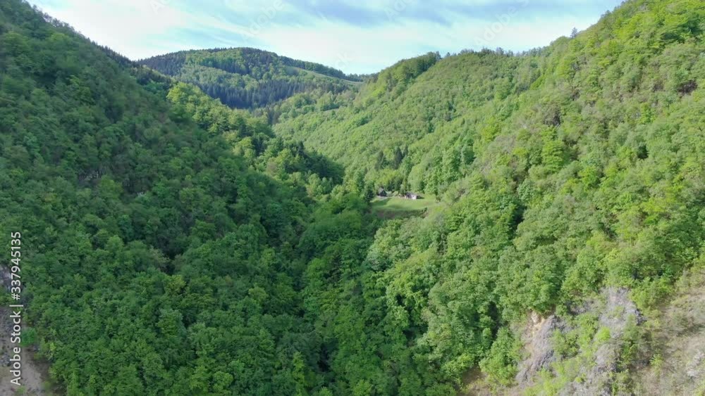Aerial shot rising among green mountains in Suhi Potok valley, Slovenia Aerial shot rising among green mountains in Suhi Potok valley, Slovenia