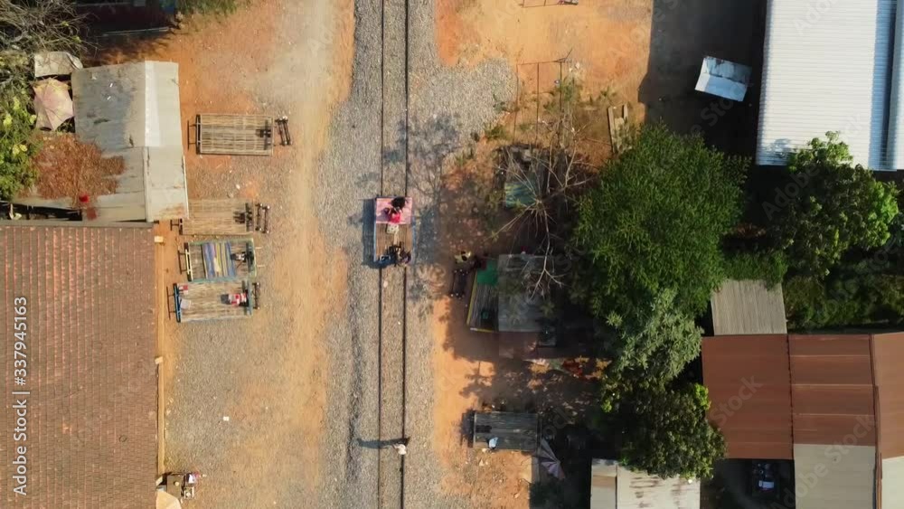 Top View Of A Bamboo Train Moving On The Railroad In Battambang, Cambodia On A Sunny Day - Aerial Shot Top View Of A Bamboo Train Moving On The Railroad In Battambang, Cambodia On A Sunny Day - Aerial Shot