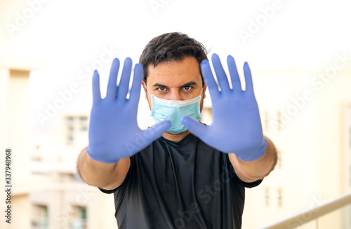 arab man wearing mask and rubber gloves during pandemic