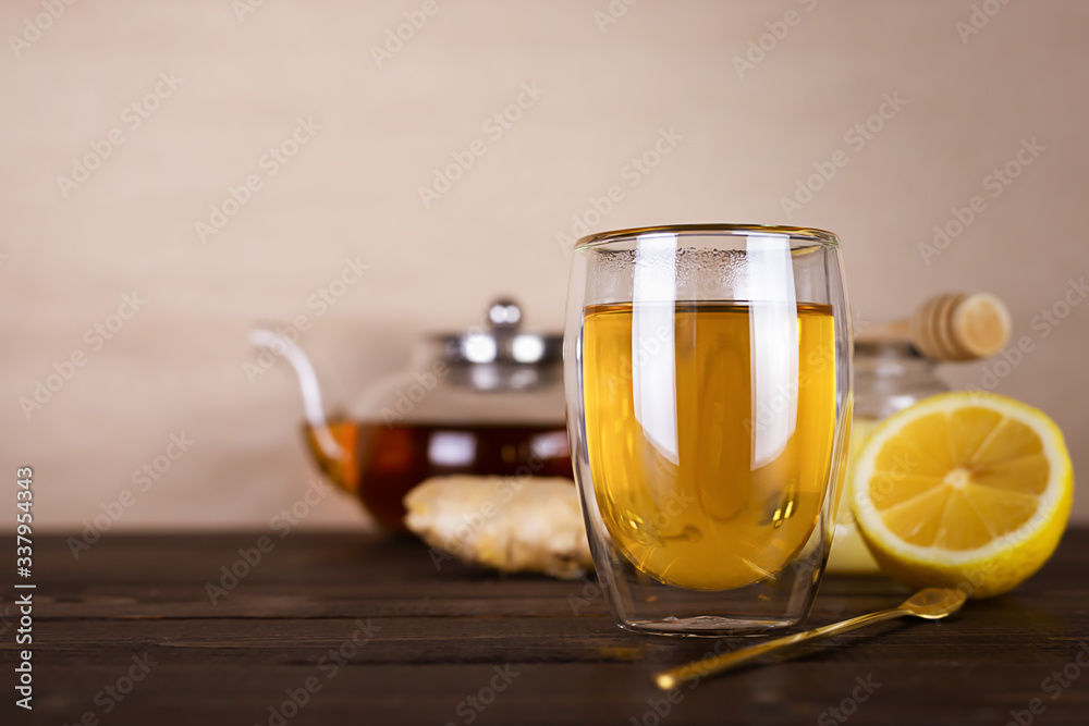Antioxidant healthy green tea with lemon, ginger and honey on a wooden table. Immune system booster food. Antioxidant healthy green tea with lemon, ginger and honey on a wooden table. Immune system booster food.