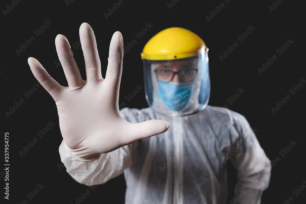 Medical doctor, nurse, surgeon, psychologist working with protective mask, glasses and gloves helping people in the days of panic, pandemic - studio shot on black background. Medical doctor, nurse, surgeon, psychologist working with protective mask, glasses and gloves helping people in the days of panic, pandemic - studio shot on black background.