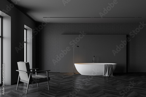 Dark grey bathroom  tub and armchair
