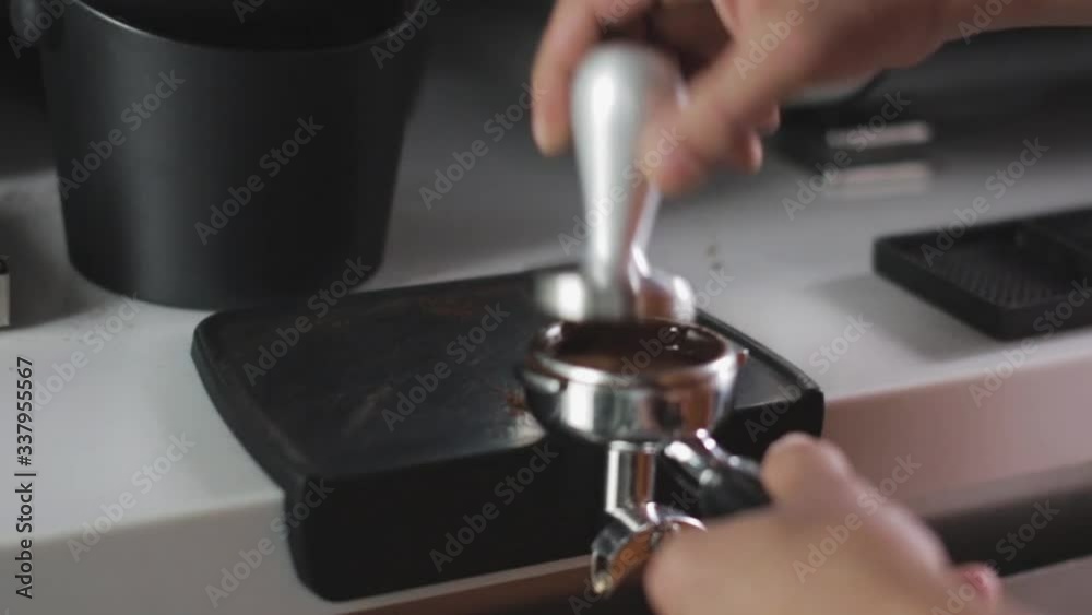 Pouring coffee stream from professional machine in cup. Barista man making double espresso, using filter holder. Flowing fresh ground coffee. Drinking roasted black coffee in the morning. Pouring coffee stream from professional machine in cup. Barista man making double espresso, using filter holder. Flowing fresh ground coffee. Drinking roasted black coffee in the morning.