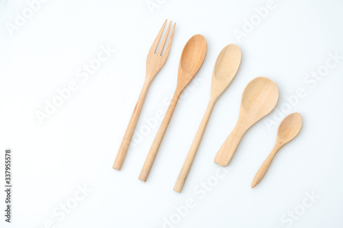 wooden spoon and fork on pastel color background