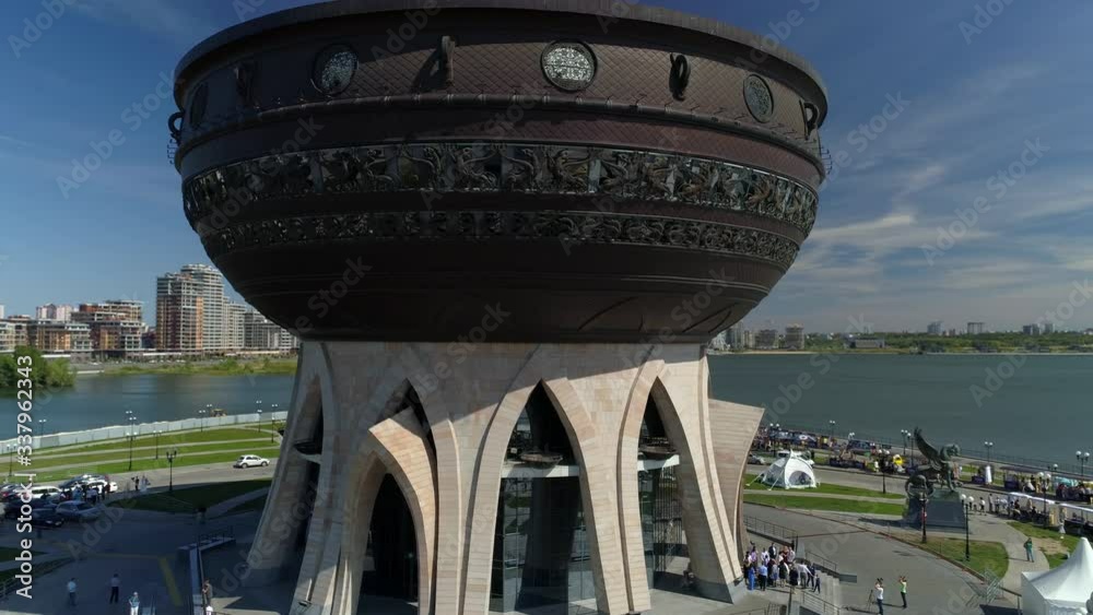Aerial around cauldron facade Kazan Russia best. Authentic national modern wedding palace ceremony. Sunny day scenic cityscape center embankment Travel attraction. People walk. Aerial around cauldron facade Kazan Russia best. Authentic national modern wedding palace ceremony. Sunny day scenic cityscape center embankment Travel attraction. People walk.