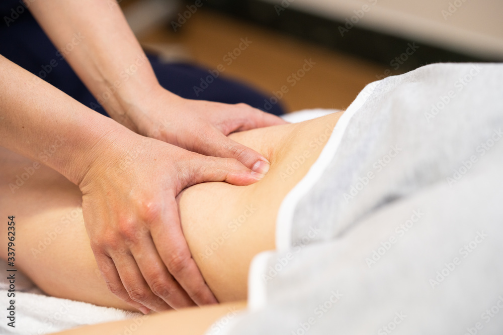 Medical massage at the leg in a physiotherapy center.