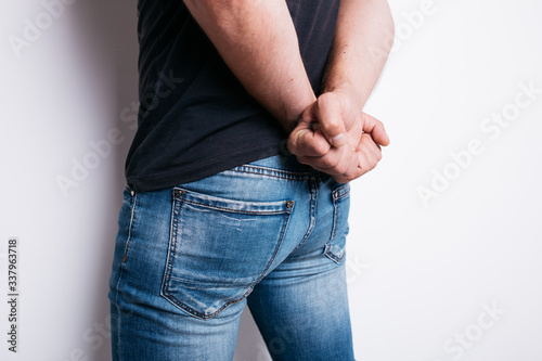 Фотография Tight muscular ass of a young man in tight jeans close-up