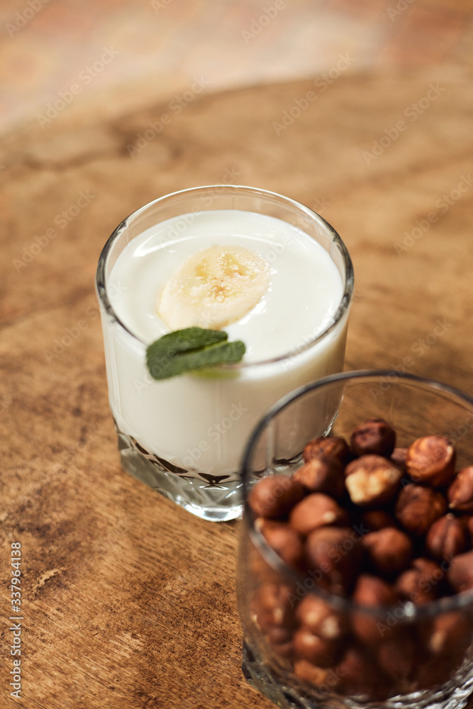 Yogurt with nuts on a wooden light background. Natural yogurt. Yogurt with nuts on a wooden light background. Natural yogurt.