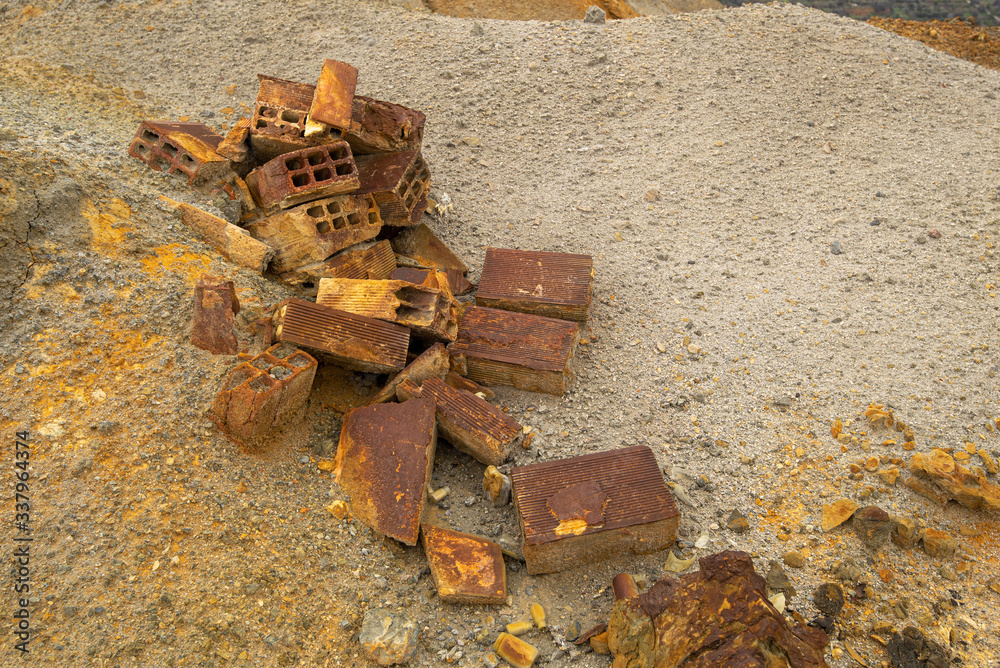 Crashed rusty building bricks on the ground Crashed rusty building bricks on the ground