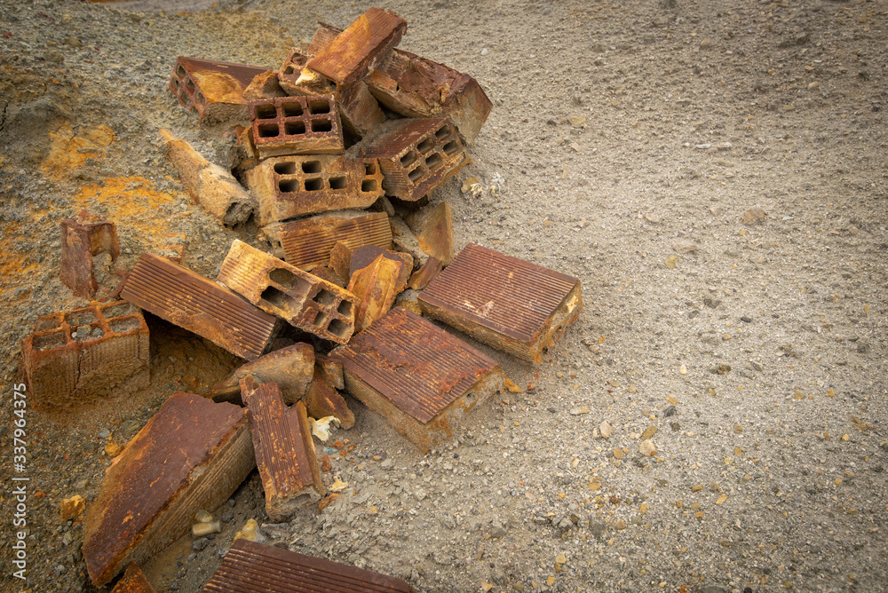 Crashed rusty building bricks on the ground