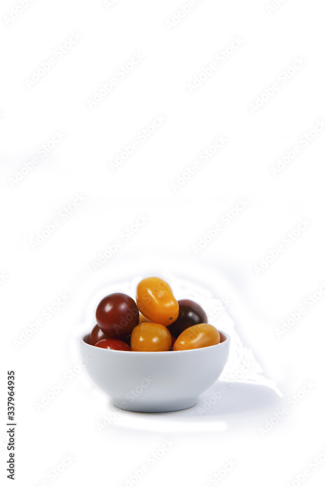 a bowl of Cherry-tomatoes isolated on white background. Vertical image