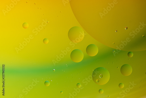 Bright abstract green and yellow background with flying bubbles