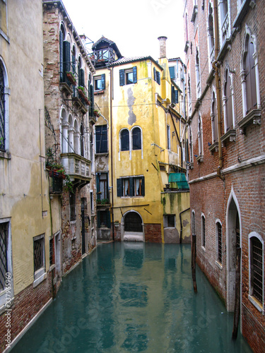 Italy, canal in Venice with old houses sweat in the rain