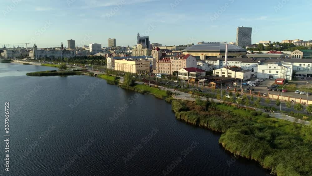 Kazan modern cityscape historical and new buildings. Beautiful Boar lake in city center fountain. Pedestrian promenade people walk. Road traffic. Summer sunny day. Russia Tatarstan. Aerial forward. 4k