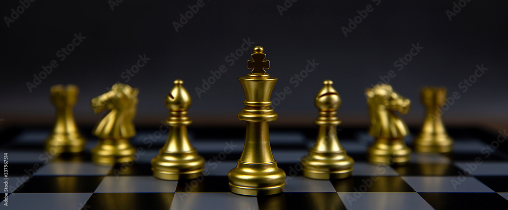The golden chess team has a king chess stands in the middle of chess board. Concepts of leadership and business strategy plans and teamwork. The golden chess team has a king chess stands in the middle of chess board. Concepts of leadership and business strategy plans and teamwork.