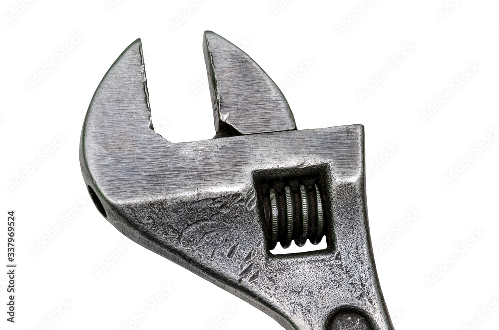 Large adjustable wrench on a white background. Insulated object. Old worn tool for mechanic. Metal texture close-up. Large adjustable wrench on a white background. Insulated object. Old worn tool for mechanic. Metal texture close-up.