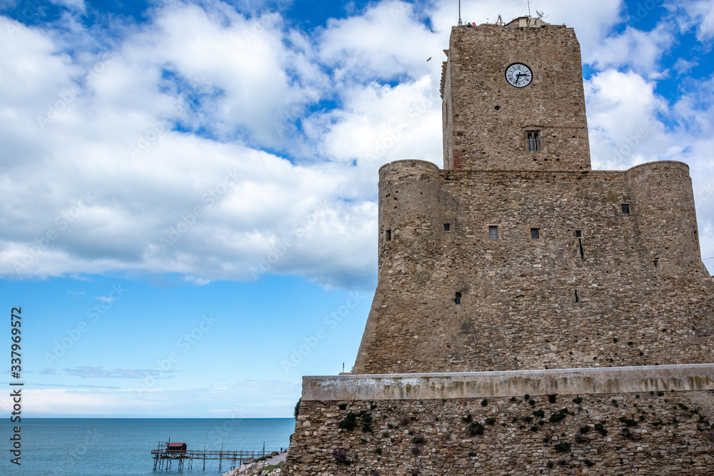 The castle and the Trabocco (fish-trap) on the beach of Termoli, trabucco is an ancient fishing machinery on wooden pilework with long arms an large net, typical of Adriatic Sea. Termoli, Molise Italy