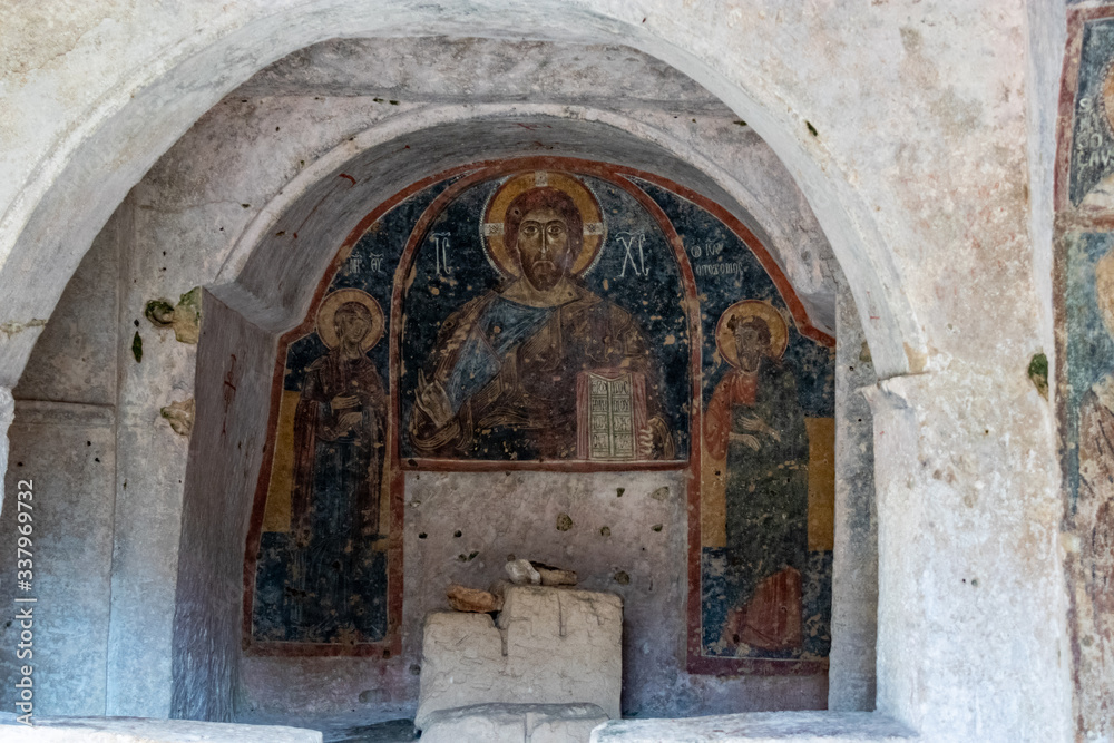 Fototapeta premium The frescoes of the rock church of Santa Margherita and cave dwellings in Mottola, Taranto, Apulia (Puglia), Italy
