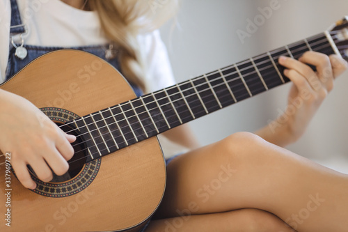 Musician Woman's Hands on the Guitar Indoors