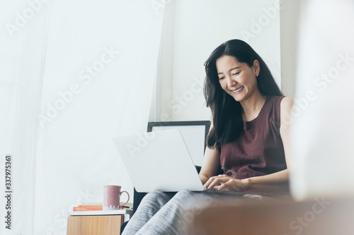 work from home.using computer.hand typing keyboard laptop online chatting search form internet while working sitting on sofa.concept for technology device contact communication business people