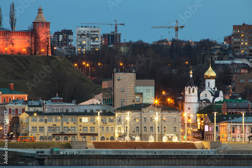 A unique perspective of Nizhny Novgorod in the evening with the city lights on against the backdrop of a beautiful sky and sunset
